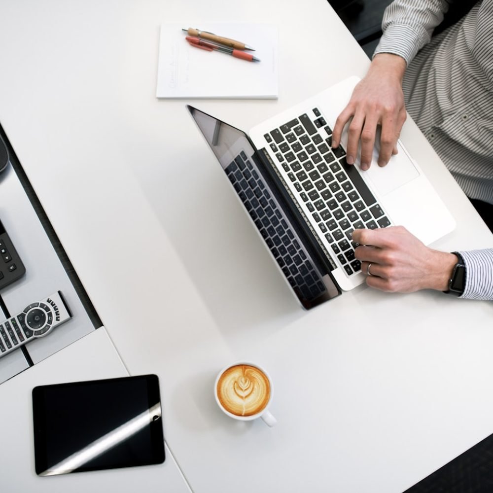 Overhead view of professional working at modern office desk
