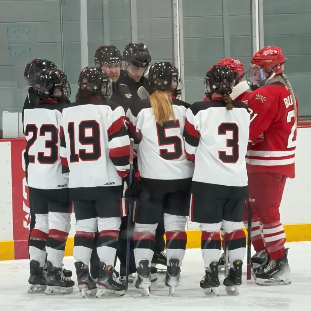 hockey players in an huddle and only numbers showing